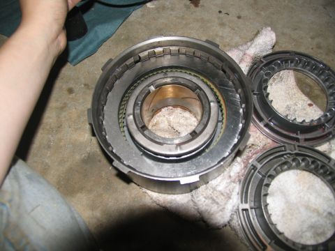 1978 Ford Bronco - A disassembled transmission clutch pack and drum are laid out on a cloth, likely during a rebuild process.