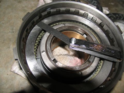 1978 Ford Bronco - A feeler gauge is used to measure the gap on a transmission part during a rebuild.