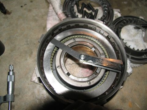 1978 Ford Bronco - A transmission drum is being measured with a feeler gauge, indicating a repair or rebuild process.