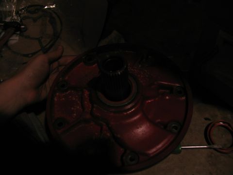 1978 Ford Bronco - A person holds a red automotive part, likely from a transmission, showing a splined shaft.