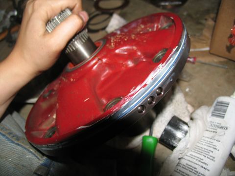 1978 Ford Bronco - Close-up of a red transmission component with a splined shaft, likely during a rebuild process.