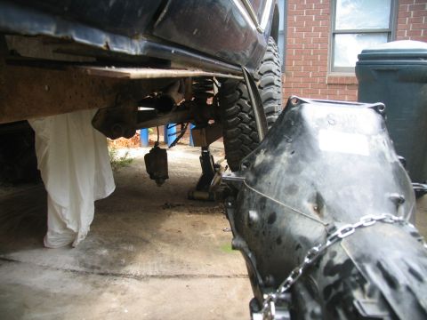 1978 Ford Bronco - The vehicle's transmission is being worked on, with the undercarriage and suspension clearly visible.