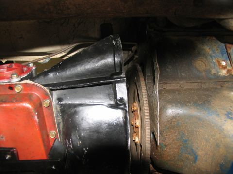 1978 Ford Bronco - Underside view of vehicle mechanical components, including a transmission and engine block, with visible rust and paint.