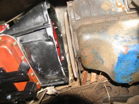 1978 Ford Bronco - Close-up view of the transmission bell housing and engine block, showing the flywheel and exhaust manifold.