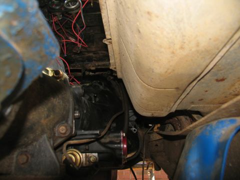 1978 Ford Bronco - Close-up of the vehicle's undercarriage, focusing on the transmission and associated components.