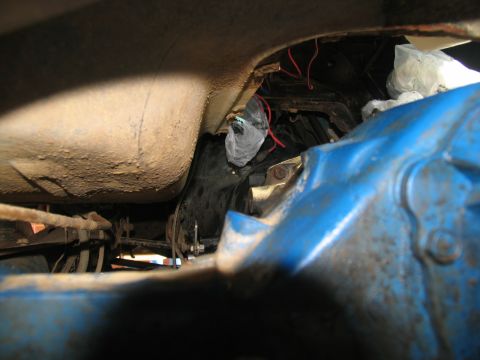 1978 Ford Bronco - Close-up view of a vehicle's undercarriage, showing mechanical components and a fuel tank.
