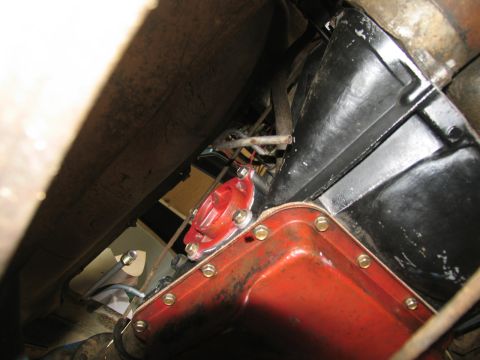 1978 Ford Bronco - Close-up view of a vehicle's transmission pan and an attached red component.