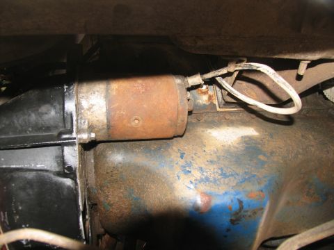 1978 Ford Bronco - Close-up view of a starter motor mounted on a vehicle's transmission assembly.