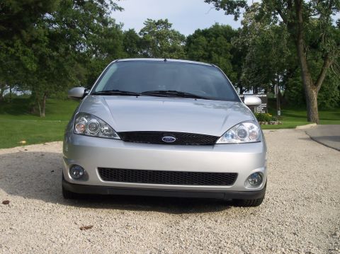 2003 Ford Focus - Front view of a silver 2003 Ford Focus parked on a gravel surface.