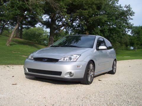 2003 Ford Focus - Silver hatchback with a black grille and fog lights is parked outdoors on a gravel surface.