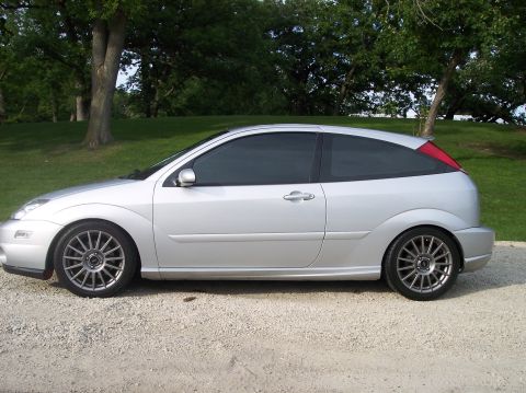 2003 Ford Focus - Side profile of a silver 2003 Ford Focus hatchback parked outdoors.