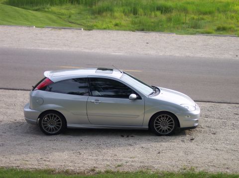 2003 Ford Focus - Side view of a silver 2003 Ford Focus hatchback with a sunroof.