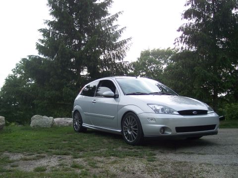 2003 Ford Focus - A silver 2003 Ford Focus hatchback is parked outdoors on a cloudy day.