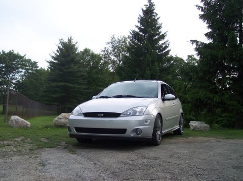 2003 Ford Focus - A silver 2003 Ford Focus hatchback is shown from a three-quarter front view, parked outdoors.