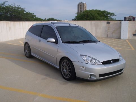 2003 Ford Focus - Silver 2003 Ford Focus hatchback parked in a garage, showing its front 3/4 view.
