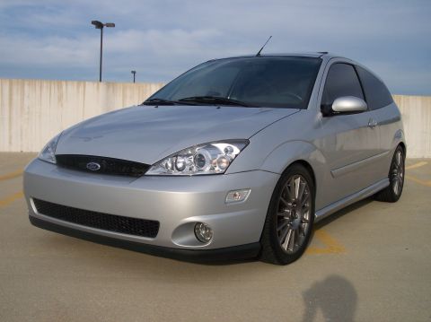 2003 Ford Focus - A silver 2003 Ford Focus hatchback is shown from the front three-quarter angle in a parking garage.