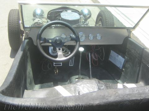 1968 Ford Mustang - The interior of a custom hot rod shows an aftermarket steering wheel, multiple gauges, and a floor shifter.