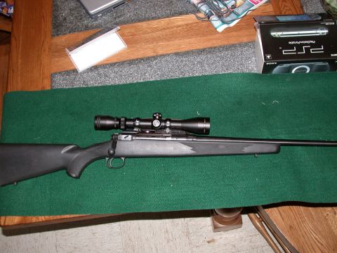 1991 Ford Bronco - A bolt-action rifle with a scope is displayed on a table.