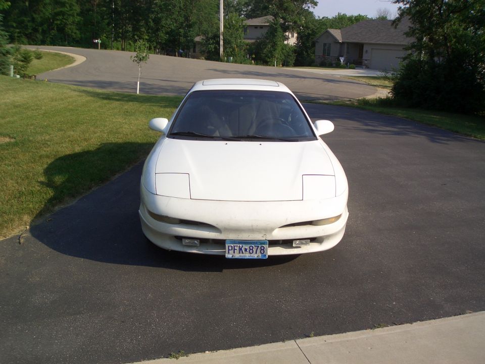 Front of a white Ford Probe coupe on a driveway