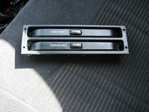 1990 Ford Taurus - This false panel pops out to reveal a small storage area.