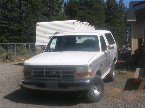1994 Ford Bronco - This 1994 Ford Bronco is seen from the front, a chrome grille and white paint.