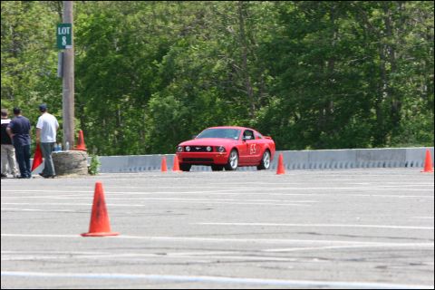 2001 Mercury Grand Marquis - A red Ford Mustang is seen on a track during an event, marked with the number 65.