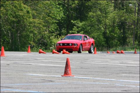 2001 Mercury Grand Marquis - A red Ford Mustang participates in an autocross event, marked with the number 65.
