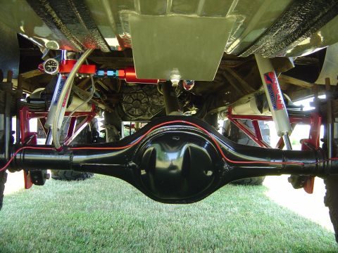 1978 Ford Bronco - This photo shows the heavily modified undercarriage of a vehicle, focusing on the rear axle and suspension components.
