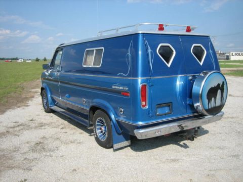 1978 Ford E250 - This custom van features a unique paint job and a spare tire cover with a western theme.