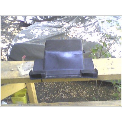 1973 Ford Ranchero - A black plastic automotive part is shown outdoors, resting on a wooden structure.