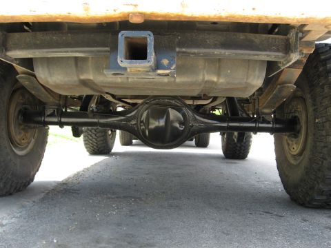 1979 Ford Bronco - The rear differential and suspension components are visible from this low-angle shot of the vehicle's undercarriage.