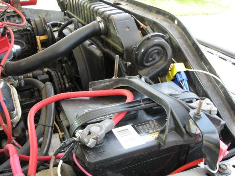 1979 Ford Bronco - Close-up of a vehicle's engine bay, focusing on the battery and cooling system components.