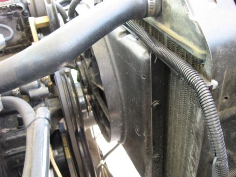 1979 Ford Bronco - The engine bay reveals the radiator and fan, essential components for cooling the vehicle's motor.