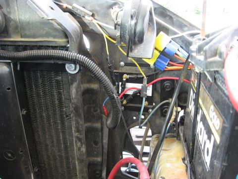 1979 Ford Bronco - The engine bay of a vehicle displays its electrical wiring, radiator, and a DieHard battery.