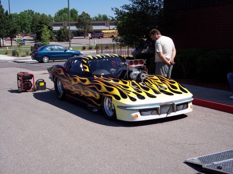 1972 Ford Ranchero - A custom drag car with a prominent supercharger and flame graphics is parked outdoors.