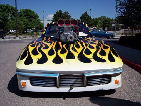 1972 Ford Ranchero - This heavily modified vehicle features a striking flame paint job and a large engine blower, making its year and model difficult to determi…