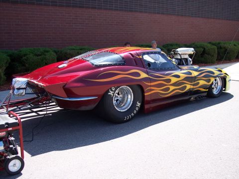 1972 Ford Ranchero - A custom drag car with a prominent flame paint job is parked outdoors next to a portable generator.