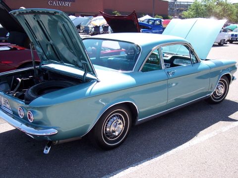 1972 Ford Ranchero - A blue coupe with hoods open is parked in a lot, with a spare tire visible in the trunk.