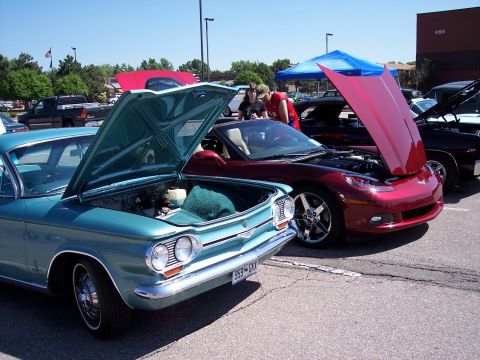 1972 Ford Ranchero - Two cars, a teal vintage model and a red modern sports car, are parked side-by-side with their hoods open.