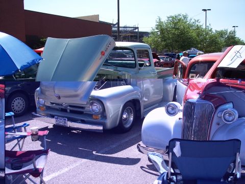 1972 Ford Ranchero - A light blue 1956 Ford F-100 pickup truck is displayed with its hood open at an outdoor car show.
