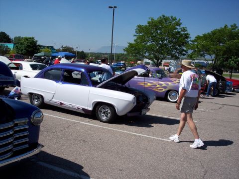 1972 Ford Ranchero - A two-door sedan with a purple top and flame decals is displayed with its hood open at an outdoor car show.