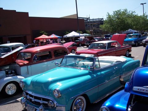 1972 Ford Ranchero - A turquoise 1954 Chevrolet Bel Air convertible is parked among other classic cars at an outdoor event.