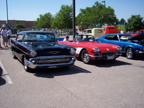 1972 Ford Ranchero - A black 1957 Chevrolet Bel Air is parked in front of a red Corvette and a blue Camaro.