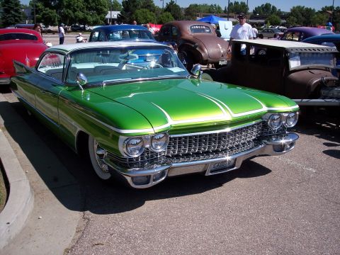 1972 Ford Ranchero - A bright green 1959 Cadillac coupe with whitewall tires and a distinctive grille is parked outdoors.