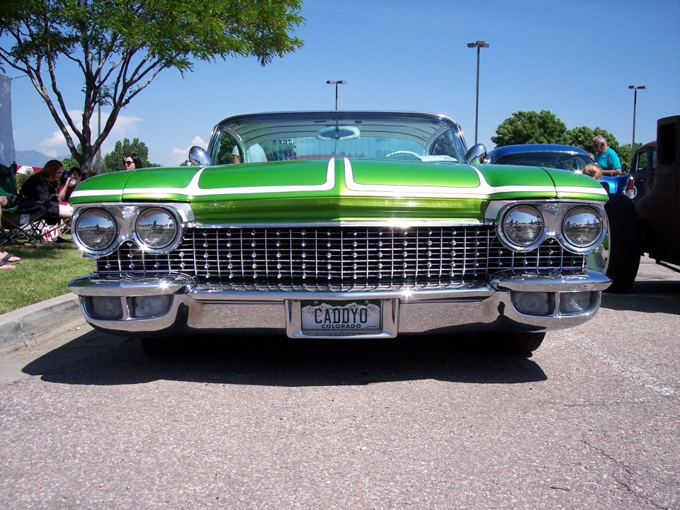 Green and white custom car front view. License plate reads CADYO COLORADO