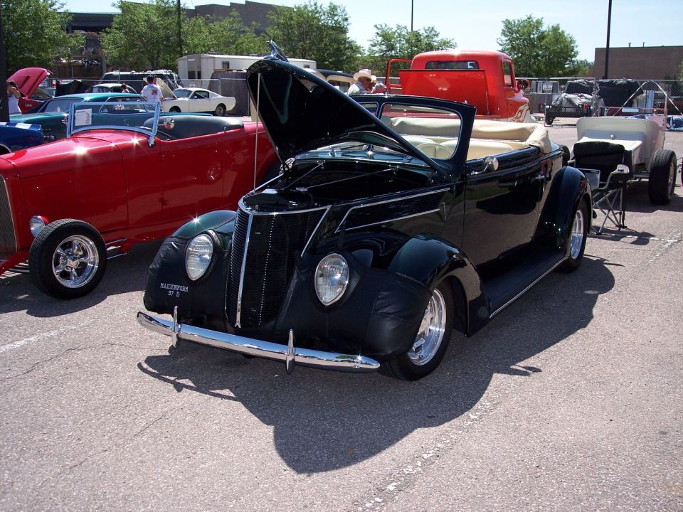 Black convertible with hood open, chrome grille, and tan interior. Text on fender reads "WATERFORD 37 D"