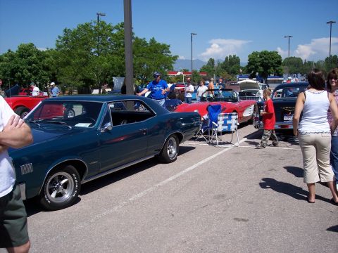 1972 Ford Ranchero - A dark teal coupe is parked at an outdoor car show with other vehicles visible.