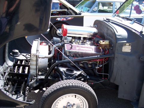 1972 Ford Ranchero - Custom V8 engine with chrome accents and headers, parked next to another vehicle with patriotic graphics.