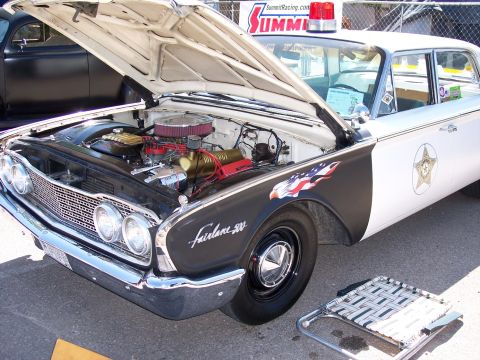 1972 Ford Ranchero - This vintage police car, identified as a Fairlane 500, is displayed with its hood up, revealing the engine compartment.