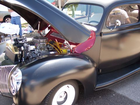 1972 Ford Ranchero - Matte black 1939 Ford Coupe with its hood open, revealing the V8 engine and yellow spark plug wires.